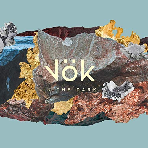 The image shows an album cover featuring a rock formation with the title "Vök - In The Dark". For accessibility purposes, a suitable alt text could be: "Album cover with rock formation and title 'Vök - In The Dark'".