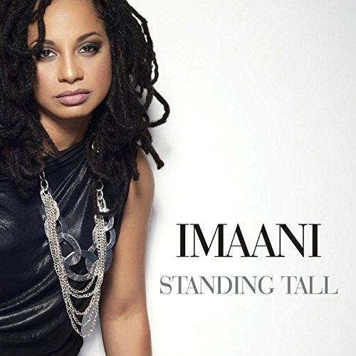Woman with dark hair and leather top on album cover with "IMAANI STANDING TALL" text.