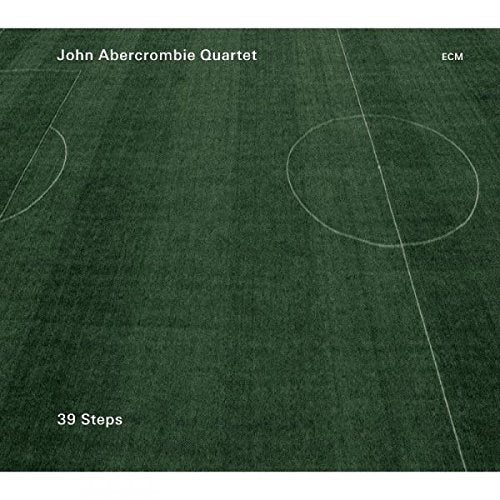 "Album cover featuring a green soccer field with white lines and text."