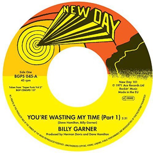Vinyl record label with yellow, orange, and black design, displaying song title and artist.