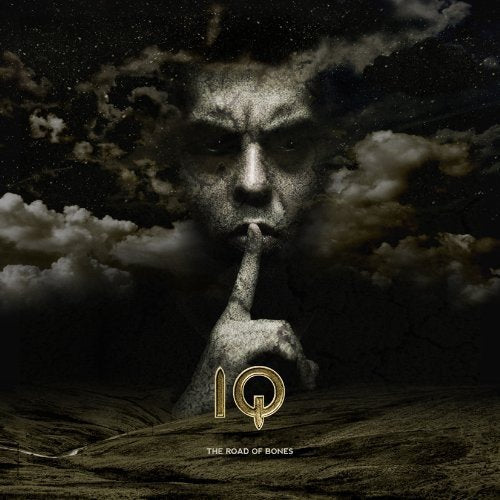 "Album cover with a man's face and 'IQ - The Road of Bones' text."