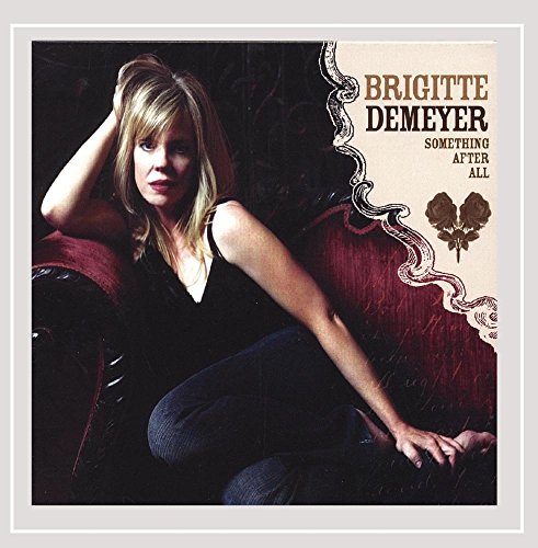 Album cover with a blonde woman sitting on a red chair.