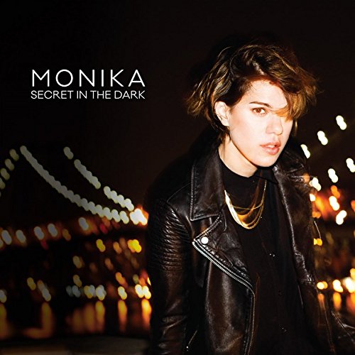 Album cover featuring a person in a leather jacket against a blurred cityscape at night.