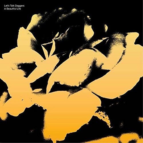 Vinyl album cover featuring a black and yellow abstract floral design.