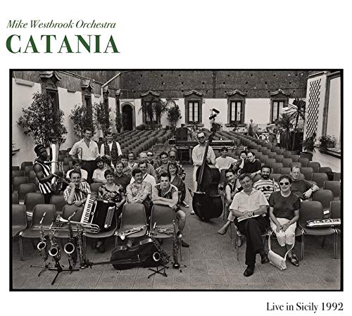 "Album cover with black-and-white photo of musicians in an auditorium, instruments visible."