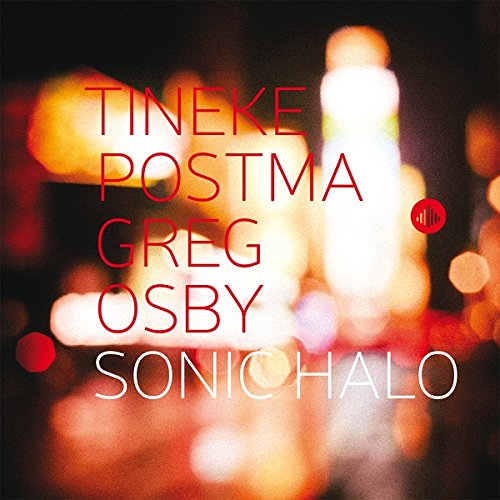 Album cover with blurred lights and artist names in red and white text.
