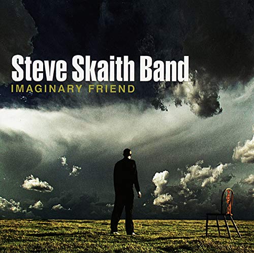 "Album cover featuring a man standing alone in a field under a stormy sky."