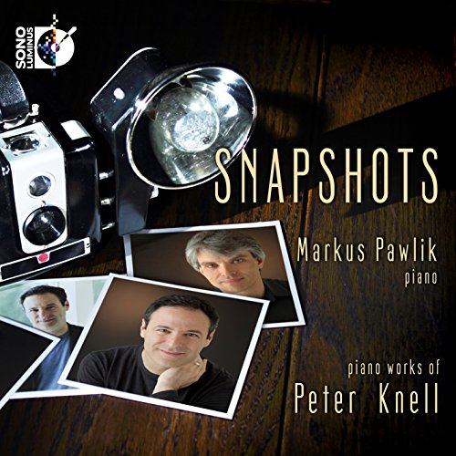"CD cover with camera, spotlight, and three photos of a man on dark wood."