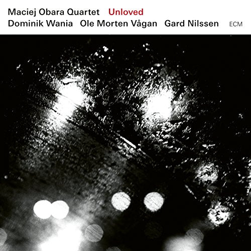 "Album cover with black and white image, white banner with artist and title information."