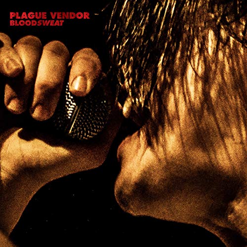 "Vinyl album cover featuring a person with wet hair holding a microphone."