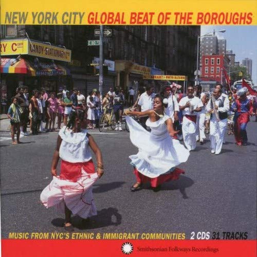"CD cover with dancers and marching band in a street, cityscape in background."