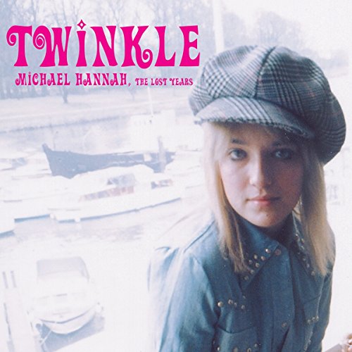 "Album cover with a blonde woman wearing a hat, outdoors scene in the background."