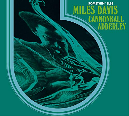 "Album cover with teal background, featuring a man playing a trumpet in a circular frame."