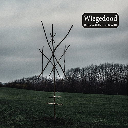 "Vinyl record cover with a bare tree sculpture in a grassy field."