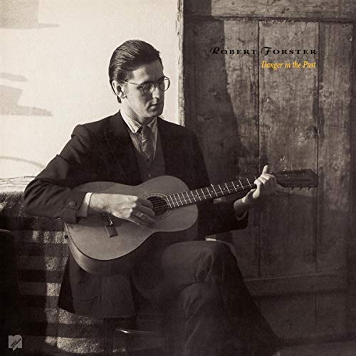 "Album cover featuring a man in a suit playing an acoustic guitar."