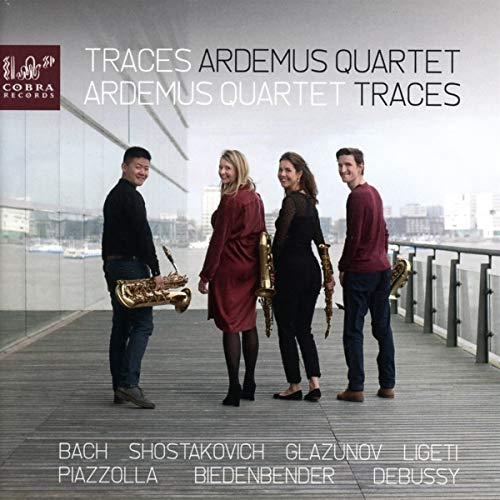 "CD cover featuring four musicians with saxophones on a wooden deck."