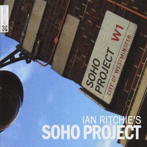 "Album cover with 'SOHO PROJECT W1' sign on a brick building and blue sky."
