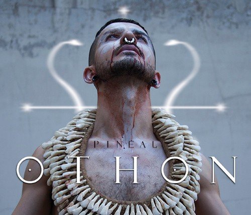 Man with blood on his face and chest, wearing a shell necklace, against a grey background.