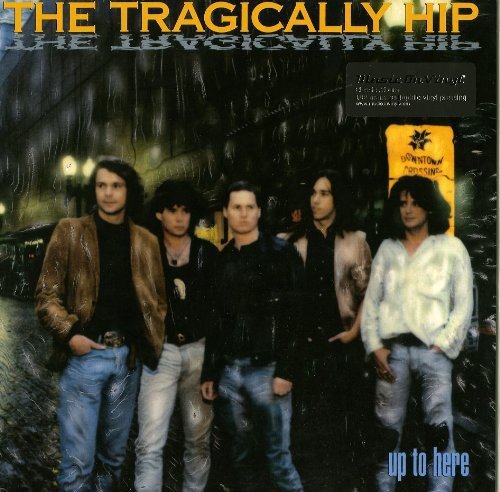 "Album cover featuring a band of five men standing in a dark alleyway."