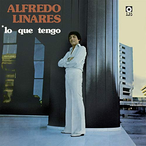 Vinyl album cover featuring a man in white standing by a modern building.