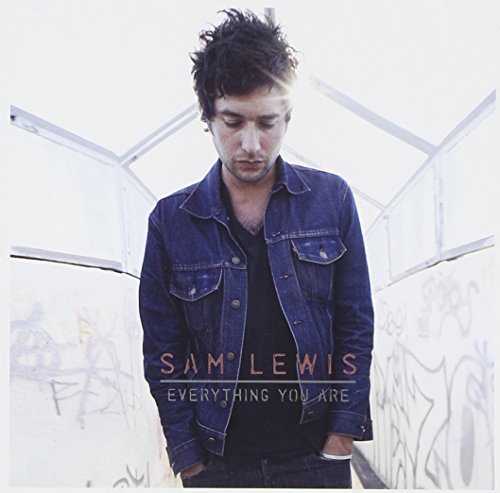 "Album cover featuring a man in denim jacket standing in a graffiti-covered tunnel."
