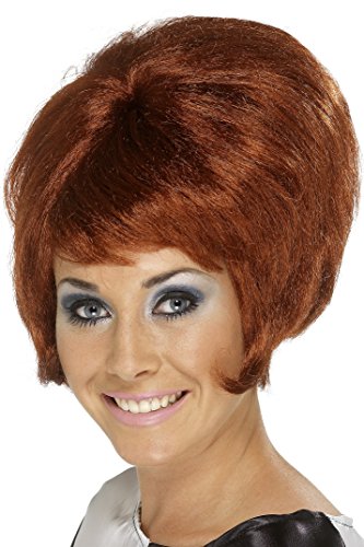 Woman wearing a red beehive wig, smiling, against a white background.