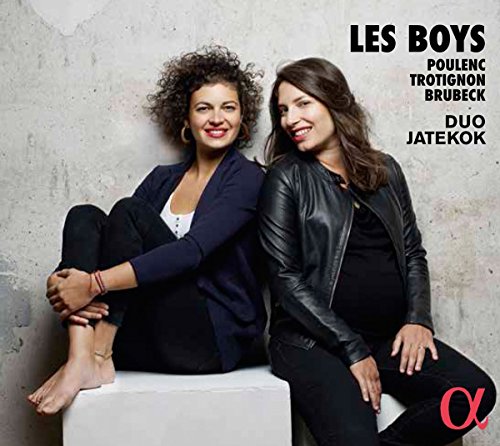 "CD cover with two women sitting on a white cube against a grey wall."