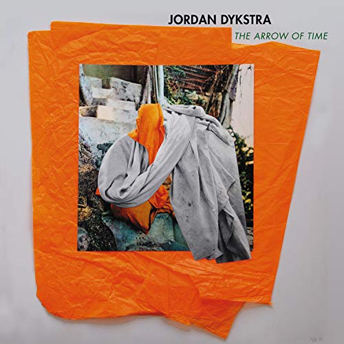 Album cover with orange tissue paper and a photo of a person in a grey robe.