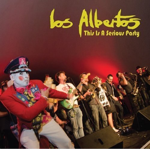 "Vinyl record cover featuring a band performing on stage with a red-lit background."
