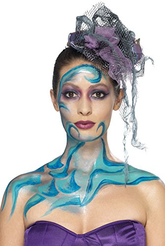 A woman with blue liquid latex designs on her face and neck, wearing a purple fascinator.