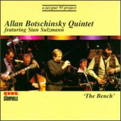 "CD cover with a jazz quintet performing on stage, yellow background."