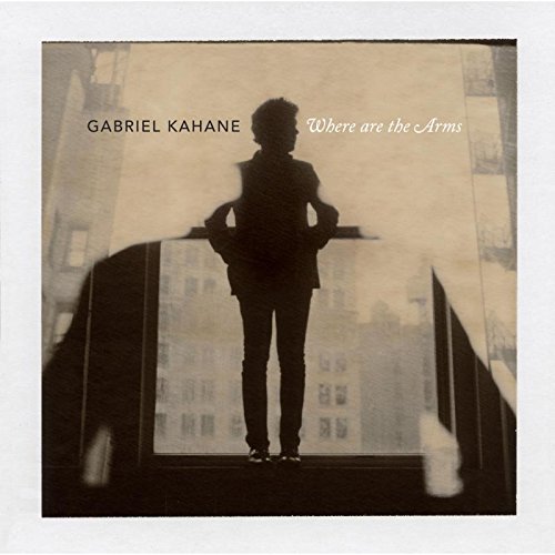 Album cover featuring a silhouette of a person on a balcony with cityscape background.