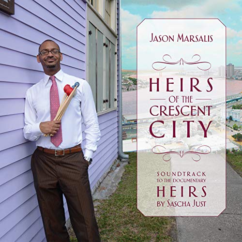 Man in white shirt and pink tie holding drumsticks beside album cover with red text.