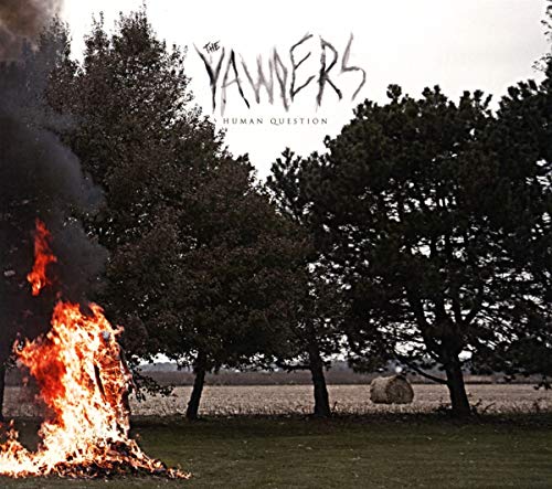 "Album cover with a burning pile in a field and trees in the background."