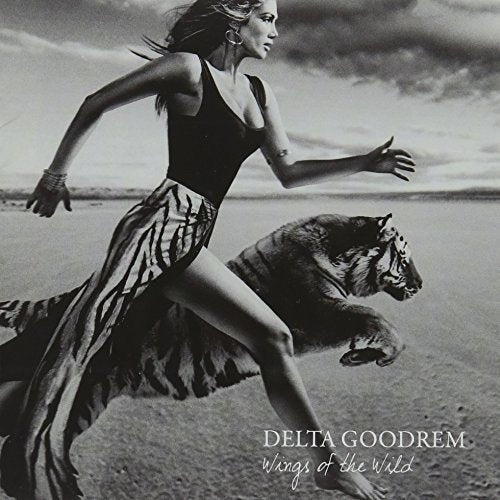 "Black and white album cover with woman running alongside a tiger."