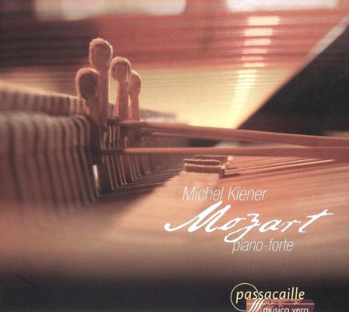 "Blurry image of a piano with 'Mozart' written in white cursive script."