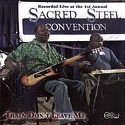 "CD cover with two musicians playing instruments on stage, banner in the background."