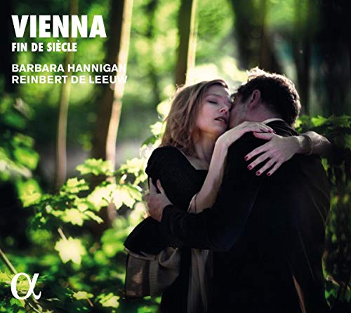 A man and woman embracing in a forest, with white text overlay.