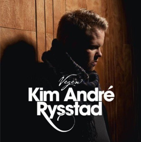 "Album cover featuring a man with short hair against a wooden background."