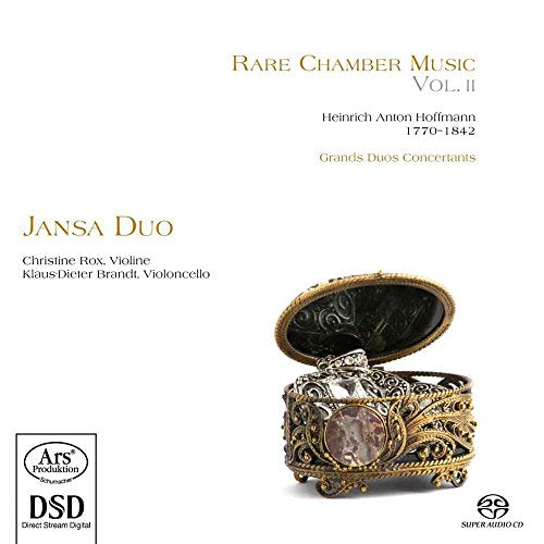 An ornate, gold music box with an open lid on a white background.
