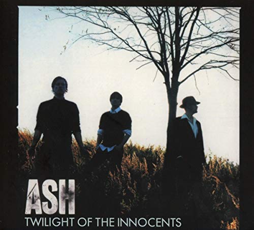 "Album cover featuring three men standing by a bare tree, silhouetted against a pale sky."
