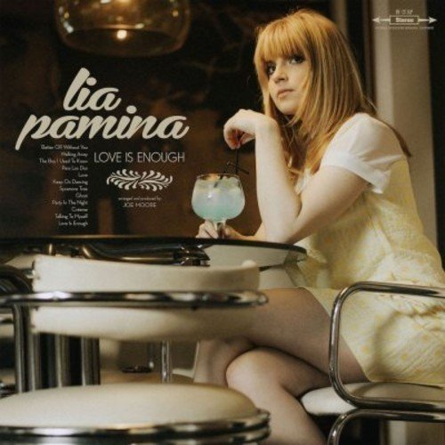"Album cover featuring a woman sitting at a table with a cocktail."