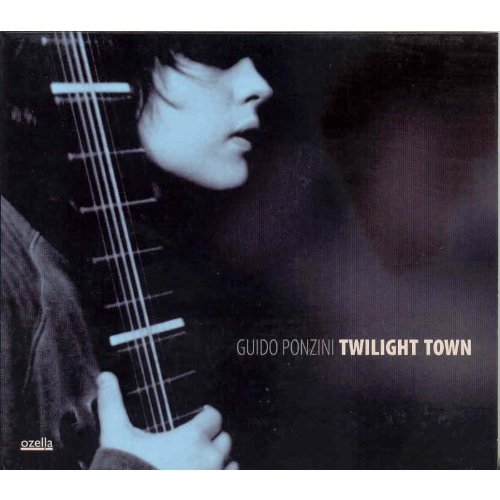 "CD cover featuring a man playing a bass guitar, with artist and album name."