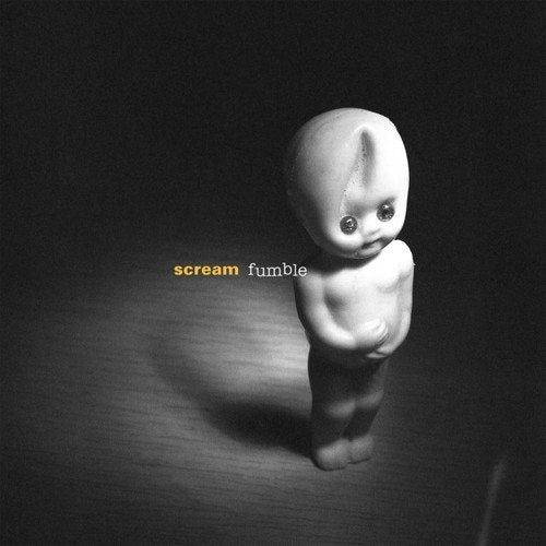 Black and white vinyl album cover featuring a Kewpie doll on a wooden surface.