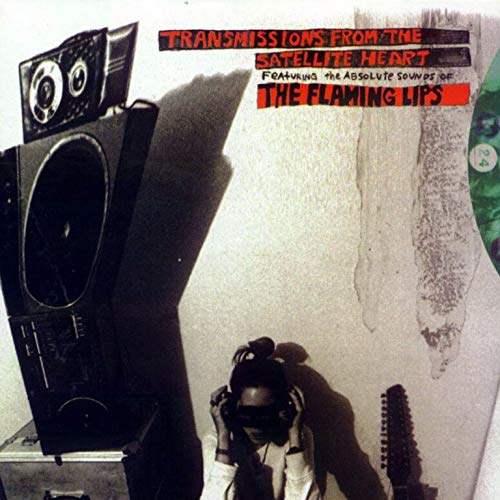 "Album cover featuring a person wearing headphones, with a speaker and guitar nearby."