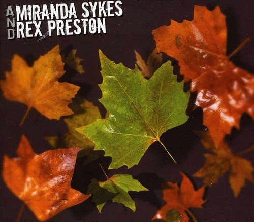 "Album cover with autumn leaves and artist names 'Miranda Sykes and Rex Preston' on dark background."