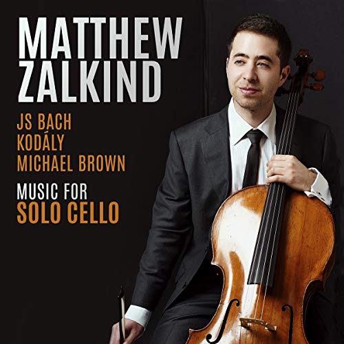 Man in a black suit holding a cello against a black background, album cover.