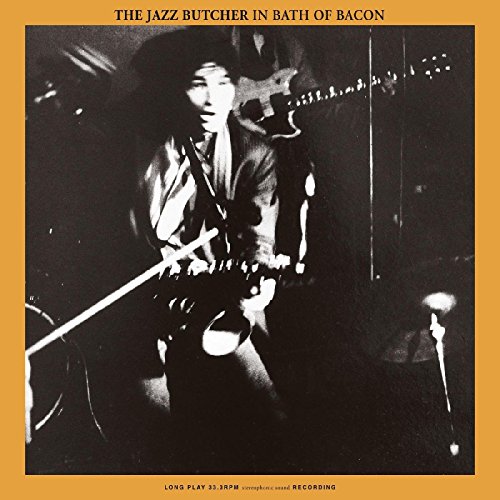 "Vinyl record cover with black and white photo of man playing guitar on orange background."