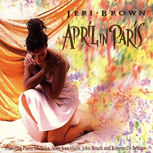Jazz album cover featuring a woman in a white dress sitting on a colorful background.