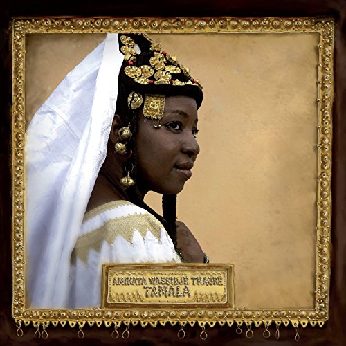 A woman in traditional attire with gold jewelry and a white veil, ornate gold frame.